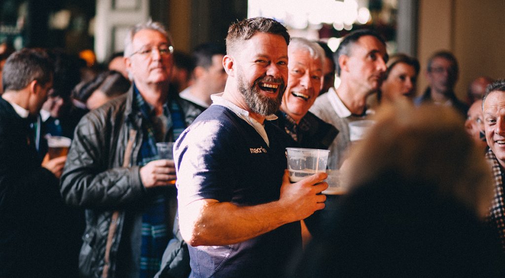 Rugby fans smiling at camera