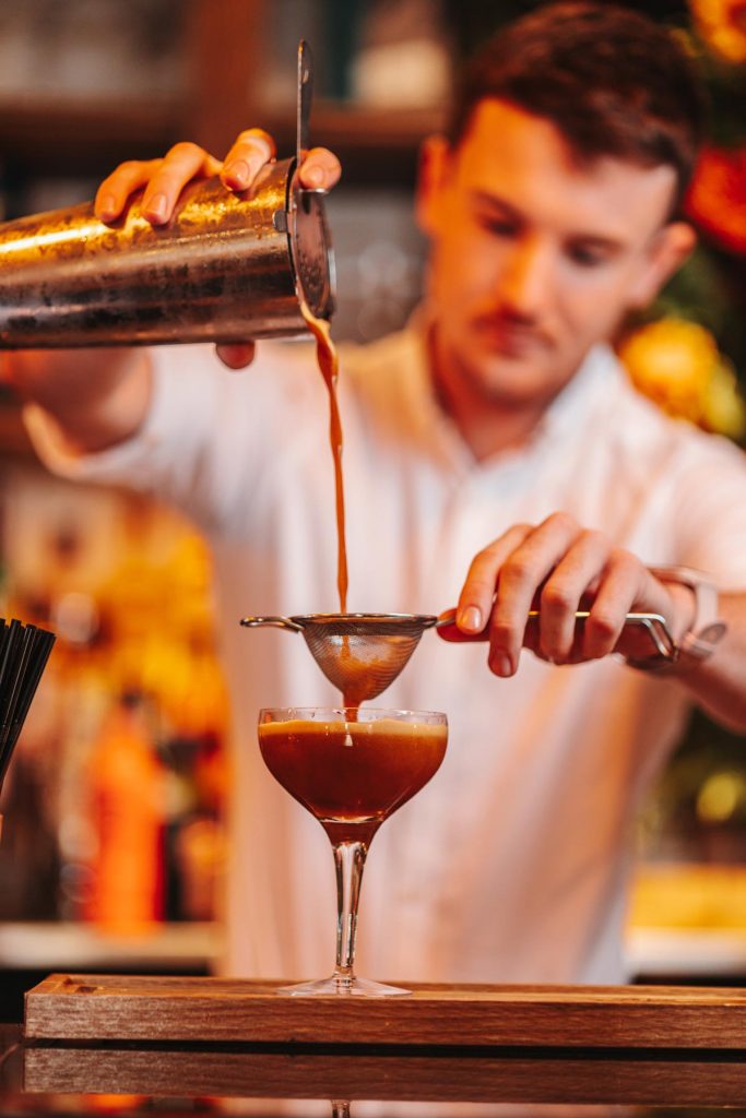 man pouring a cocktail