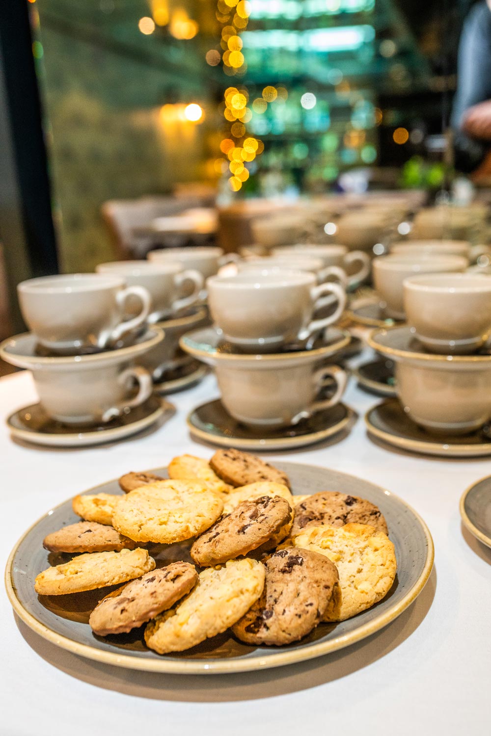 Cookies on a table with coffee mugs