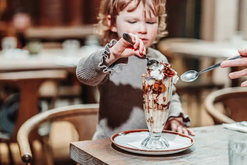 Kid eating ice cream sundae